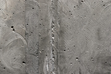 Gray, rough, concrete background texture. Stone wall with holes and various splashes