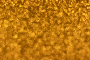 Golden sparkling glitter bokeh background, christmas abstract defocused texture. Holiday lights