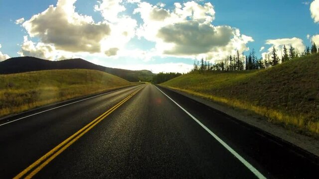 Time Lapse Shot Of Vehicle Moving On Road Amidst Green Trees And Plants In Forest - Creede, Colorado