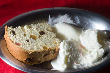Panettone with various ice creams in a metal bowl ,copy space