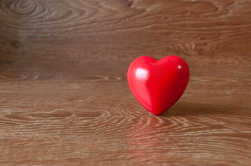 Heart of red on a background of brown boards.