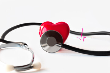 Mock up of a human heart with a phonendoscope and a fragment of a cardiogram on a white background...