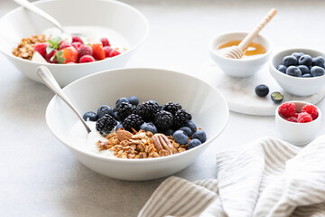 Breakfast, Granola with yogurt and berries on a concrete background