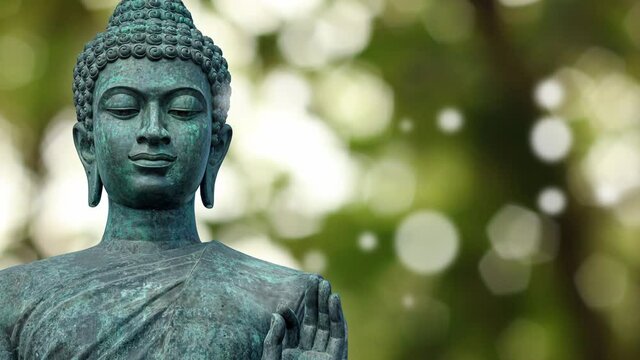 Old buddha statue with natural bokeh background