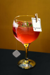 Aruba, cocktail with gin, ice, red fruit tea and pink pepper