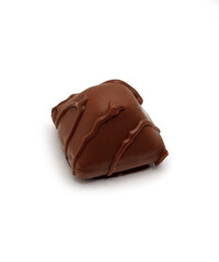 one triangular chocolate candy on a white background