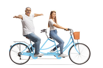 Mature man and a young female on a tandem bicycle