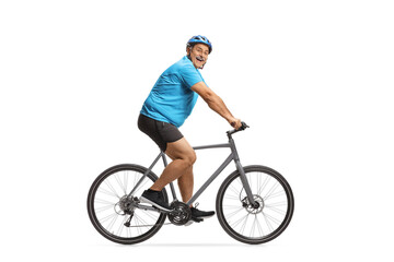 Obraz premium Happy mature male cyclist riding a road bike