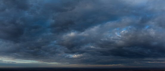 Dark thick clouds in the sky. Abstract panorama with blurred blue clouds.