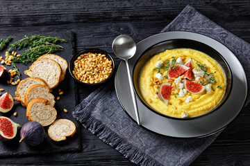 Pumpkin cream soup with thyme with feta and figs