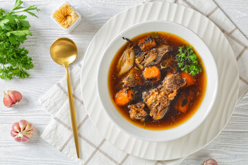 beef broth of beef meat on bones with veggies