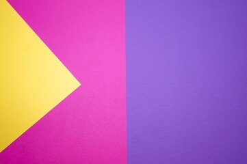 Graphic background of different geometric shapes in three colors: pink, yellow, purple.