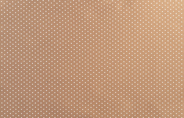 Background of beige felt fabric with small white peas.