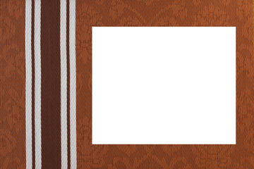 Brown fabric background with monogram pattern and a white middle.