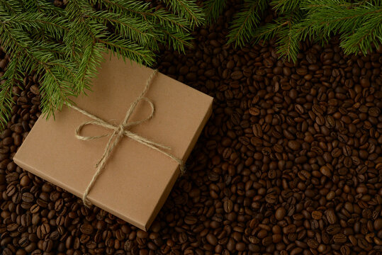 Craft gift boxes on coffee beans texture background. Copy space for text. Original Christmas or new year background