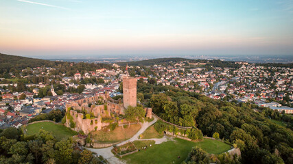 Aerial view over castle Königstein am Taunus to skyline of Frankfurt Main at horizon at sundown