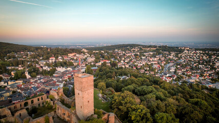 Aerial view over castle Königstein am Taunus to skyline of Frankfurt Main at horizon at sundown