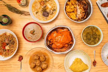 Set of food dishes prepared in a takeaway kitchen with roast chicken, typical Spanish legumes stews, beef meatloaf, potato omelette and arroz noodles with sautéed vegetables