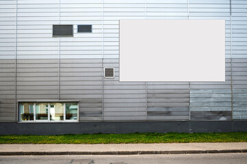 Fototapeta na wymiar blank white billboard for advertisement on the facade of building, outdoor advertising concept
