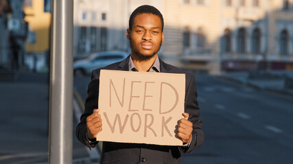 Tired frustrated desperate Young adult businessman lost business holding cardboard table Need Work...