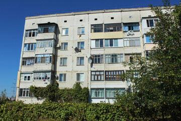 Multi-apartment five-story panel house, built in the USSR, a dormitory area of ​​the city in Ukraine in the summer, Eastern Europe. Topic rent, real estate, CIS country