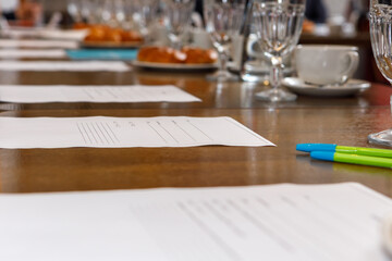 Business papers are spread out on the table.