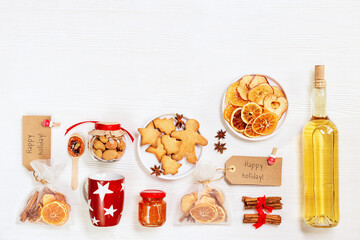 Christmas holiday flatlay preparate gifts, Ingredients for hot mulled wine as diy gift, handmade present with dried fruits, red cup honey, spices