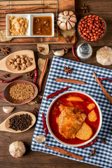 Chicken Massaman Curry on white bowl. Muslim curry or mussaman curry.  Muslim style chicken and potato or chicken mussaman curry.