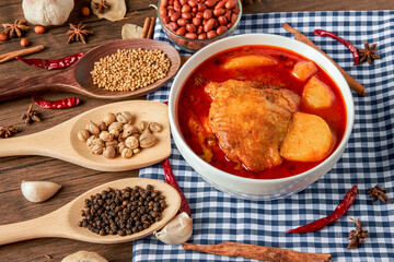 Chicken Massaman Curry on white bowl. Muslim curry or mussaman curry.  Muslim style chicken and potato or chicken mussaman curry.