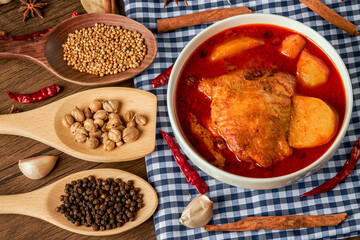 Chicken Massaman Curry on white bowl. Muslim curry or mussaman curry.  Muslim style chicken and potato or chicken mussaman curry.