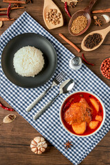 Chicken Massaman Curry on white bowl. Muslim curry or mussaman curry.  Muslim style chicken and potato or chicken mussaman curry.