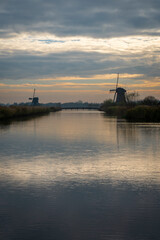 Fototapeta na wymiar River and windmills at Kinderdijk in Holland at sunset