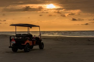  Golf cart parked on beach near sunset in Port Aransas, Texas © Lamar