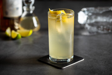 Luxury cocktail and cocktail shaker on black stone background