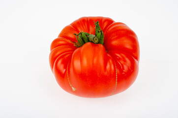 Single ripe red beef tomato isolated on white background. Studio Photo
