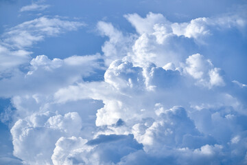 White big clouds in the blue sky on a sunny day. Clouds background.