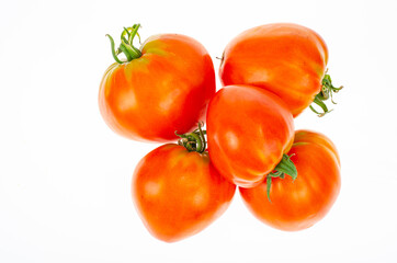 Red tomatoes in shape of heart on white background. Studio Photo