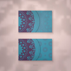 Business card template in turquoise color with Indian purple pattern for your personality.