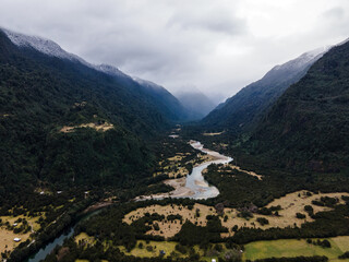 Aerial view of the Cochamo valley with its snow-capped mountains and its characteristic river.