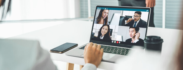 Fototapeta Business people in video call meeting proficiently discuss business plan in office and virual workplace . Telework conference call using smart video technology to communicate colleague . obraz