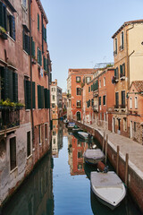 Fototapeta na wymiar Venice, Italy - 10.12.2021: Traditional canal street with gondolas and boats in Venice, Italy. High quality photo