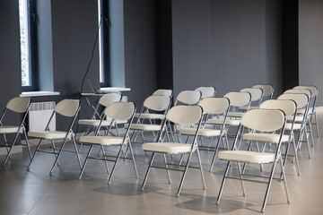 rows of seats in grey interior of modern empty conference hall for business meetings