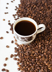 cup of aromatic coffee on a white background and scattered coffee grains. good morning . kind of sveru. flat lay. place for text. coffee time.
