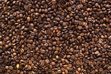 roasted aromatic coffee beans on a dark background. coffee background. flat lay with place for text. view from above.

