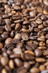 roasted aromatic coffee beans on a dark background. coffee background. flat lay with place for text. view from above.
