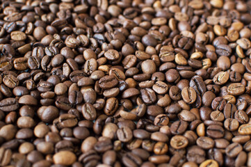 roasted aromatic coffee beans on a dark background. coffee background. flat lay with place for text. view from above.
