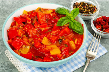 Vegetable dish of stewed sweet peppers and tomatoes, lecho, vegetarian menu. Studio Photo.