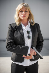 Beautiful professional female spy agent woman bodyguard posing with gun
