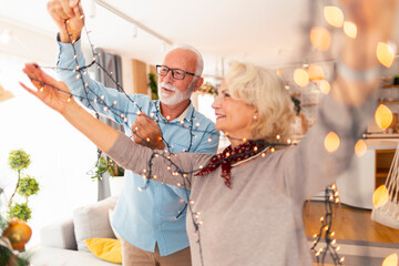 Senior couple decorating home for Christmas