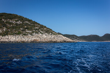 Fototapeta premium Beautiful uninhabited islands surrounded by crisp blue Mediterranean sea near the coast of Kas, Antalya, Turkey.